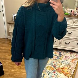 Green long sleeve turtleneck sweater.